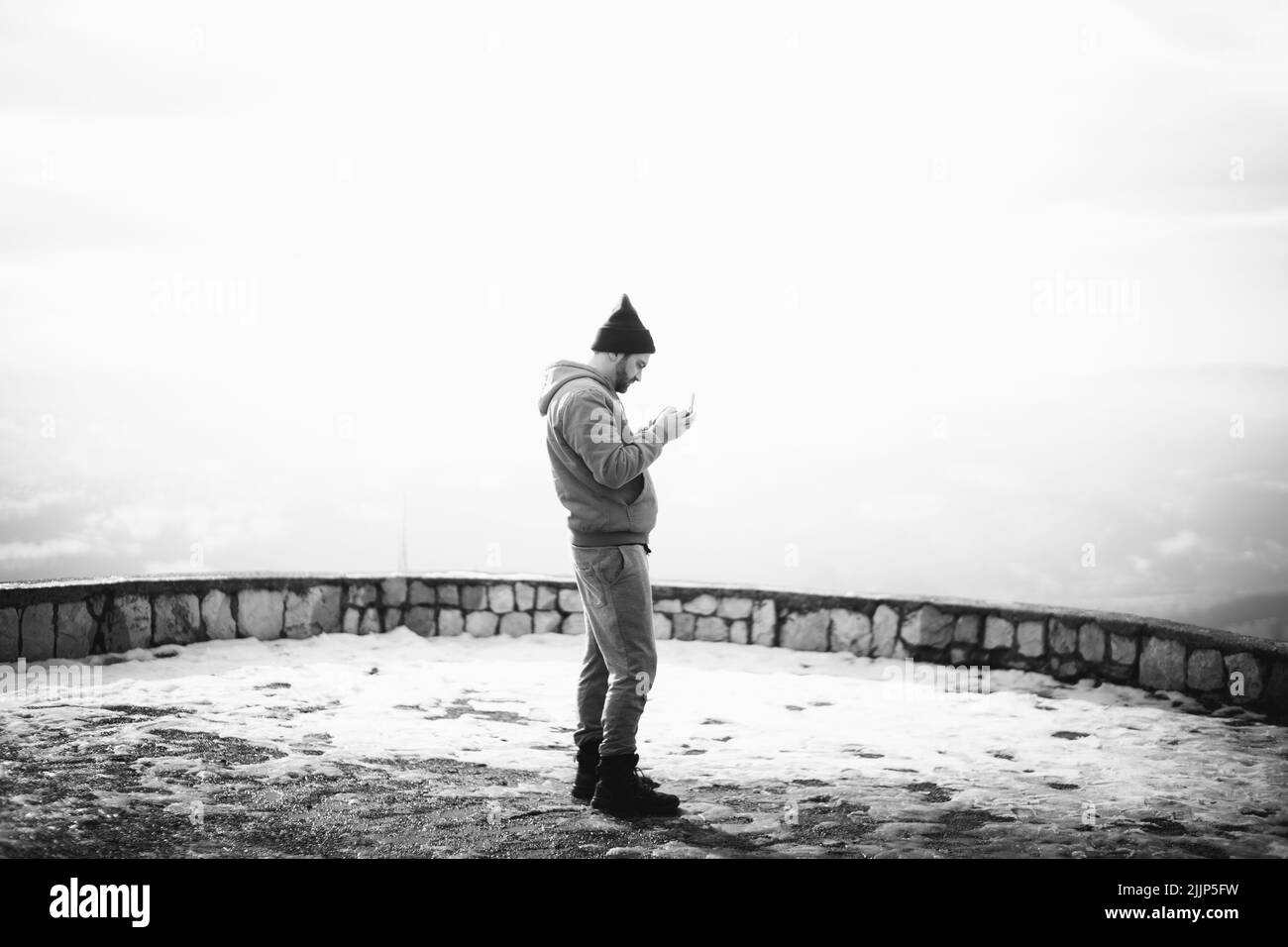 A grayscale shot of young male controlling the drone with remote control Stock Photo