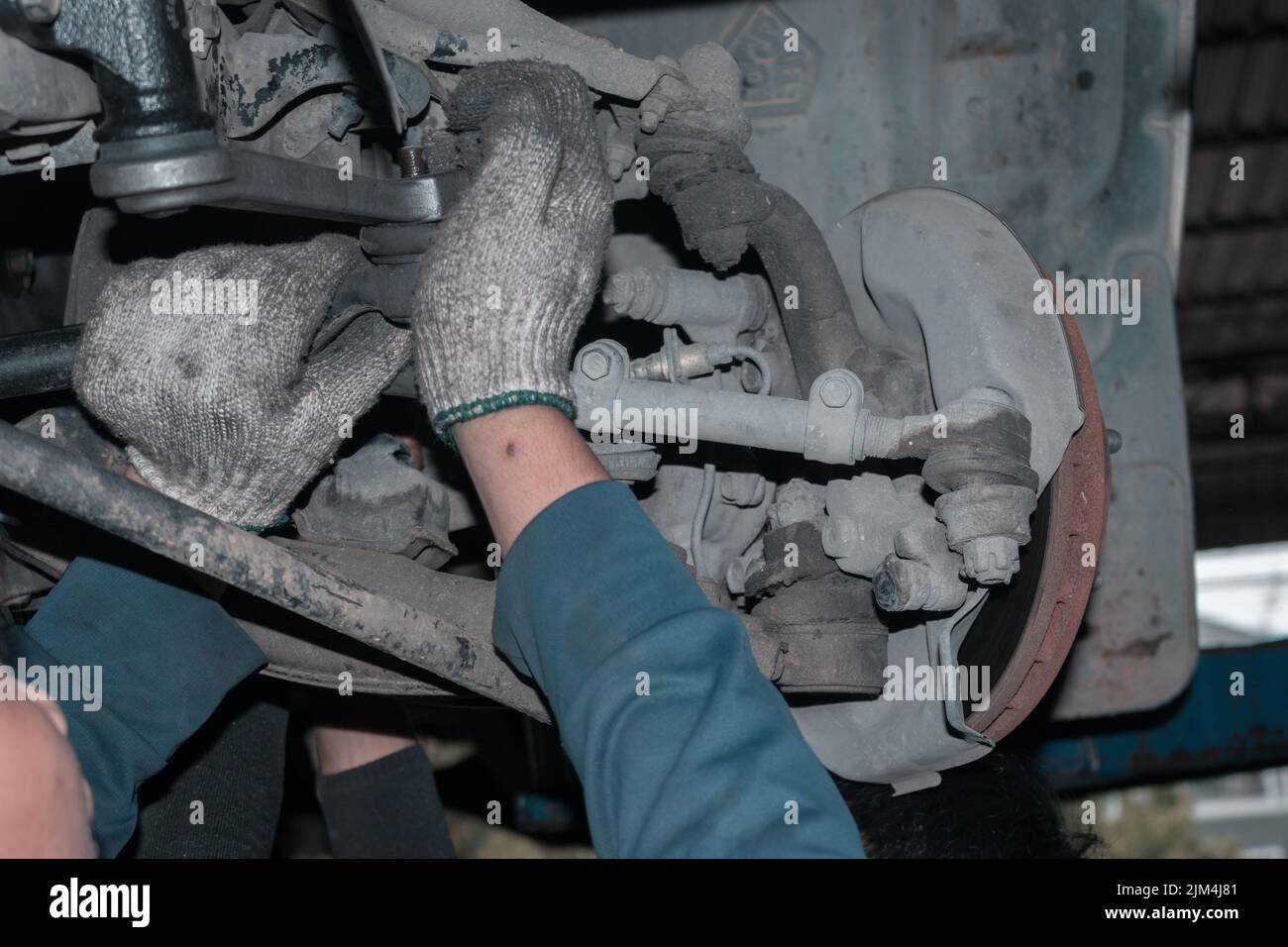 The mechanic is checking the engine. The mechanic is checking the engine. Stock Photo