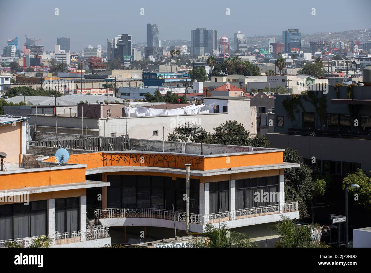 Tijuana, Baja California, Mexico - September 11, 2021: Gang graffiti covers buildings in downtown Tijuana. Stock Photo