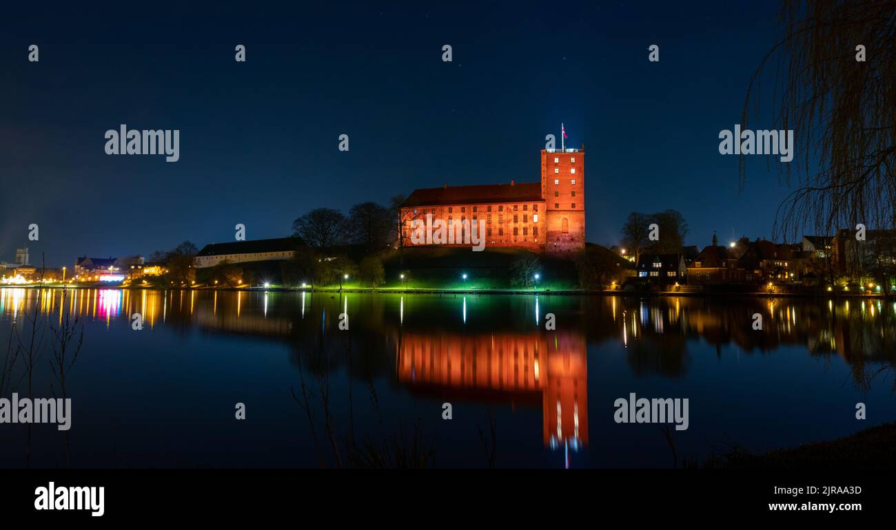 An aerial view of Koldinghus castle surrounded by water in night Stock Photo