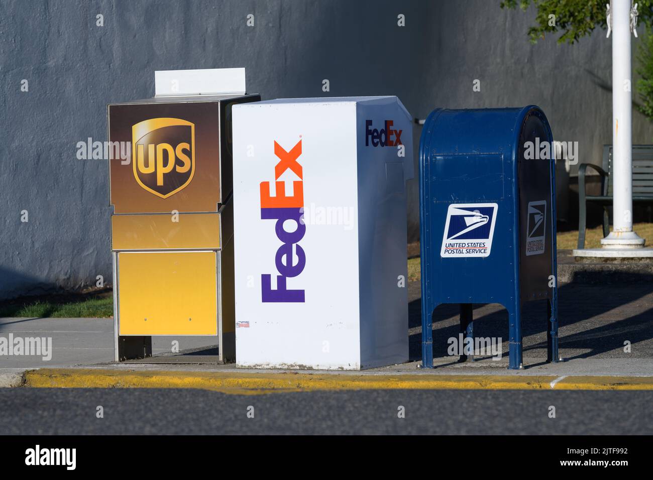 Snohomish, WA, USA - August 29, 2022; Row of drop boxes for UPS, FedEx, and United States Postal Service with brand and logo at curbside Stock Photo