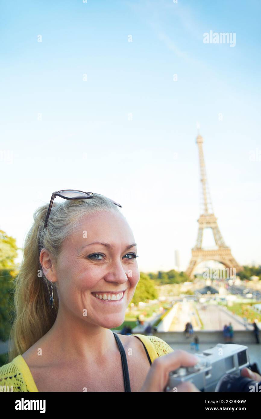 Paris is amazing. Portrait of a beautiful young woman taking photos while sight seeing in the Paris. Stock Photo