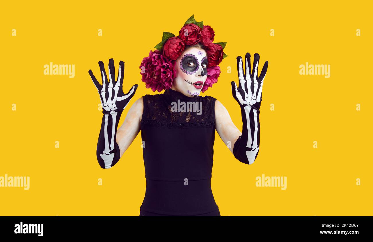 Young woman in Catrina costume gets scared at Day of the Dead or Halloween party Stock Photo