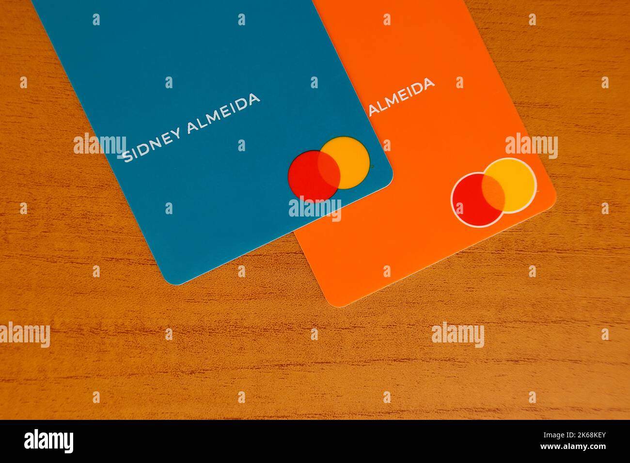 Minas Gerais, Brazil - July 09, 2022: green and orange credit cards with Mastercard brand Stock Photo