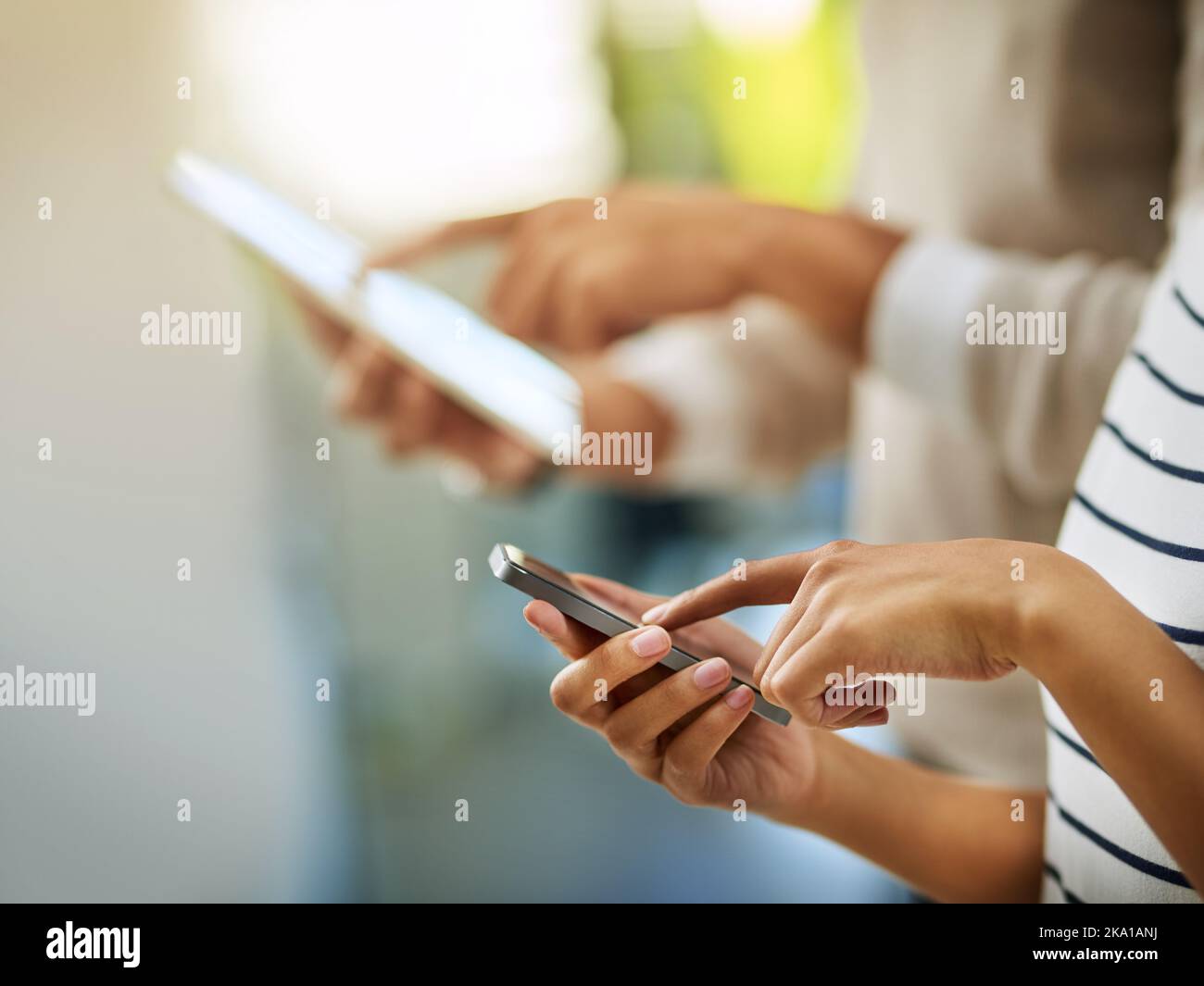 Technology is part of our lives. two unrecognizable businesspeople browsing on a phone and digital tablet. Stock Photo