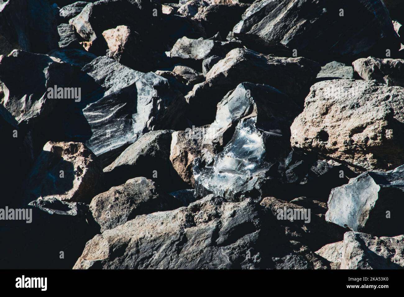 Close-up on obsidian melted into the stone heap. Stock Photo