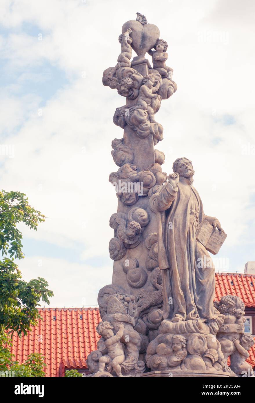 St Cajetan cofounder of Theatines is seen with a heart and little children. The tall statue  is on the Charles Bridge in Prague, Czech Republic, Stock Photo