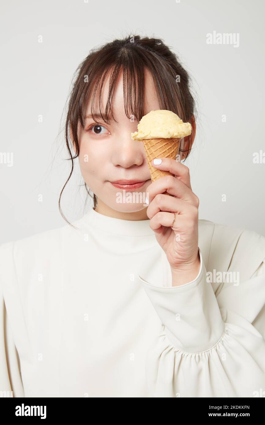 Young Japanese woman eating ice cream Stock Photo