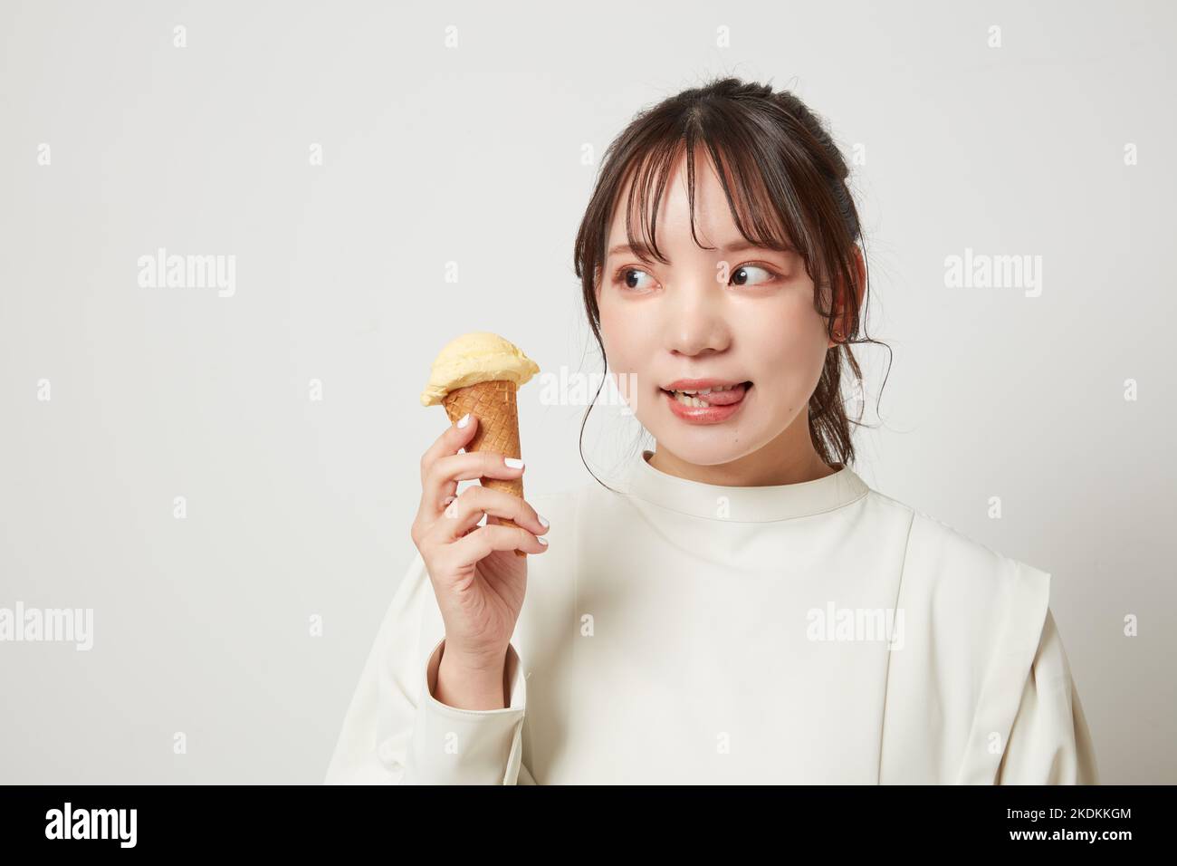 Young Japanese woman eating ice cream Stock Photo