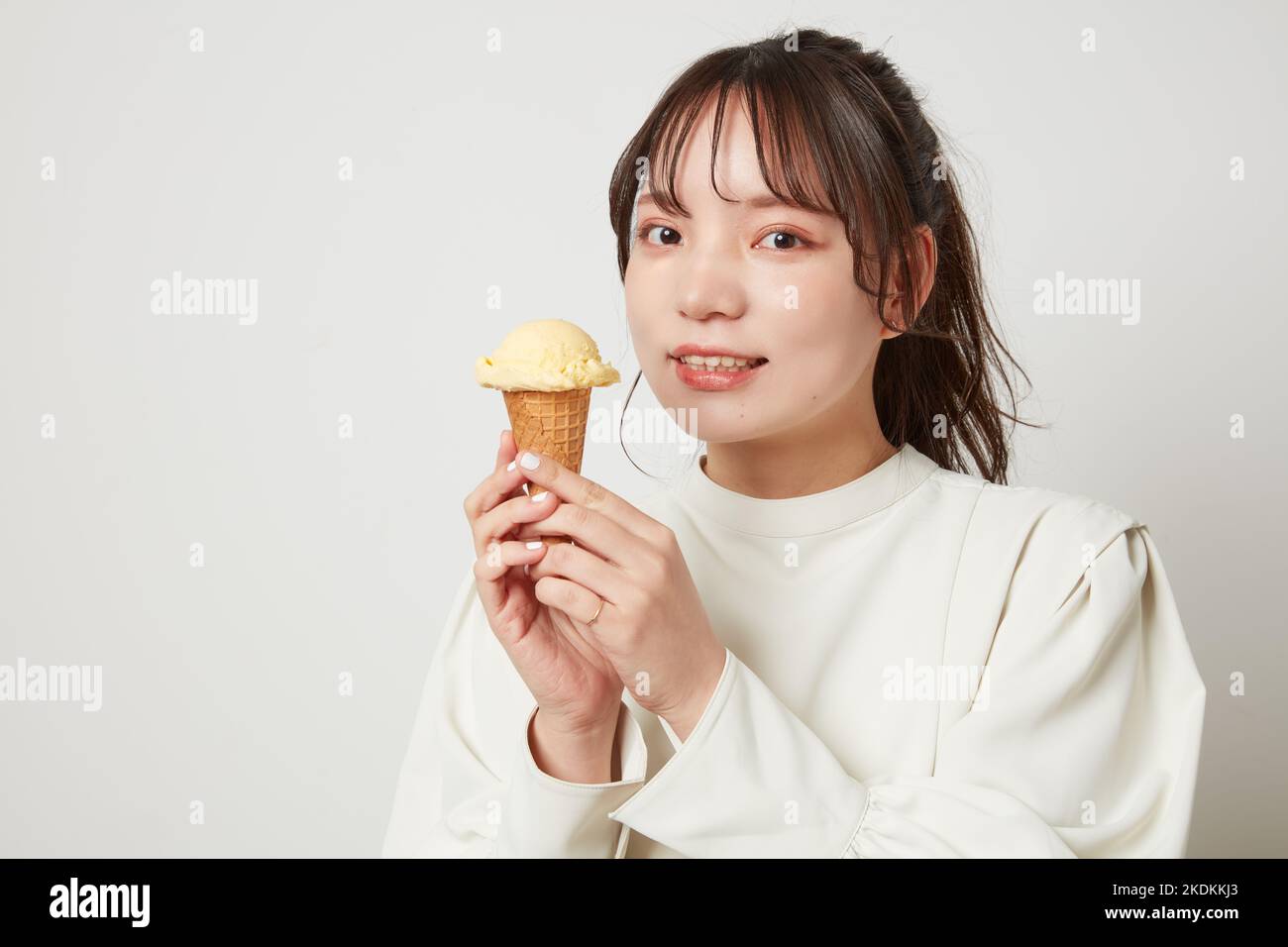 Young Japanese woman eating ice cream Stock Photo