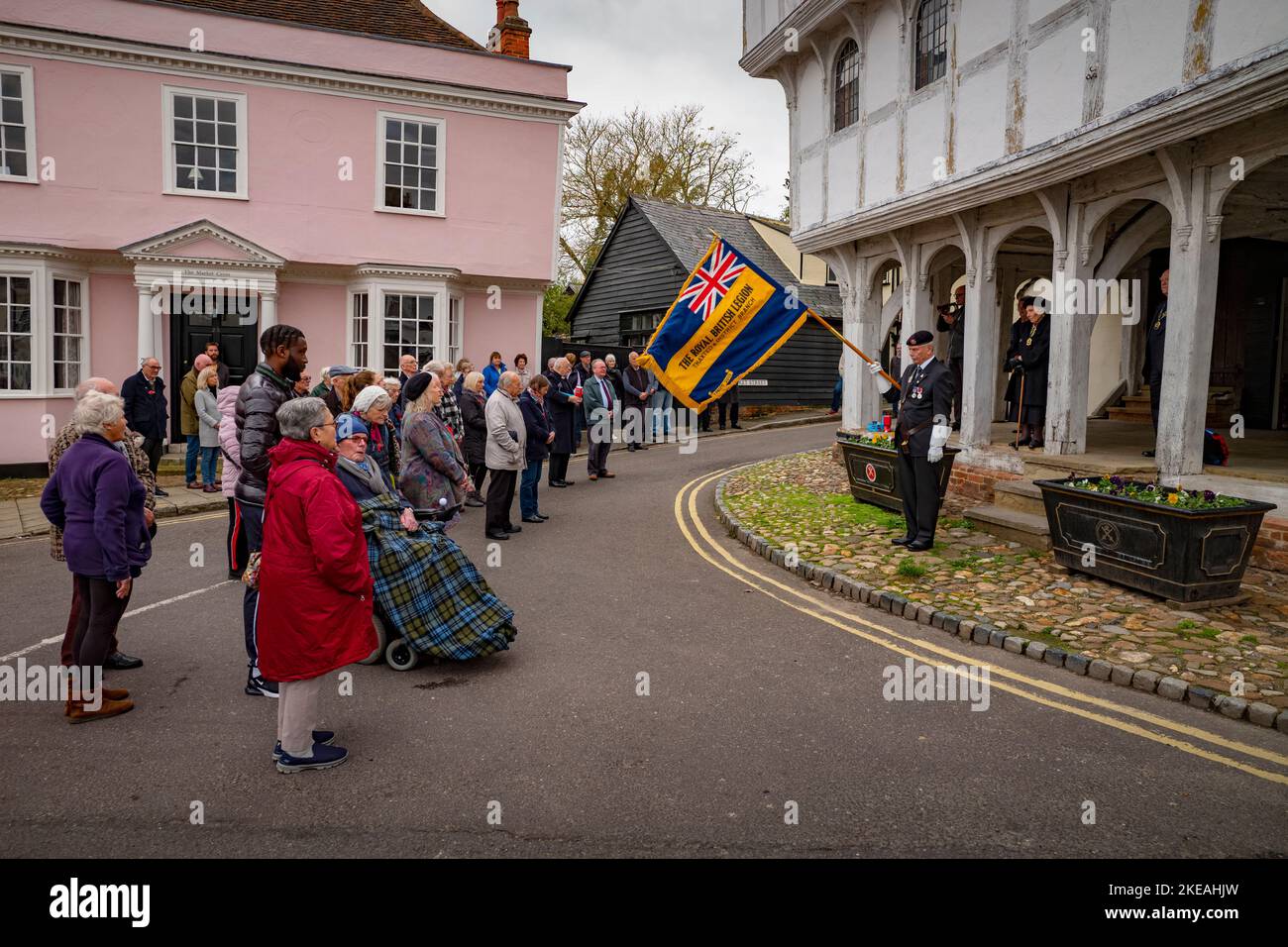 Thaxted Essex England  Armistice Day 11 November 2022 A small town remembers the fallen of all wars. At the going down of the sun, we shall remember them…Armistice Day in Thaxted, Essex, England when at 11 o'clock on the 11th day of the 11th month (11th of November) residents of Thaxted and thousands of other small and large communities up and down the British Isles and further abroad remember those who fell in all conflicts arond the world since the end of the First World War. Seen here: Mick Mizon formerly of the Royal Gree Jackets, Standard Bearer for the local Royal British Legion, lowers Stock Photo