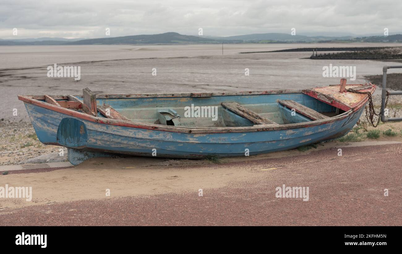 Old blue rowing boat on the promenade at Morecambe Lancashire Stock Photo