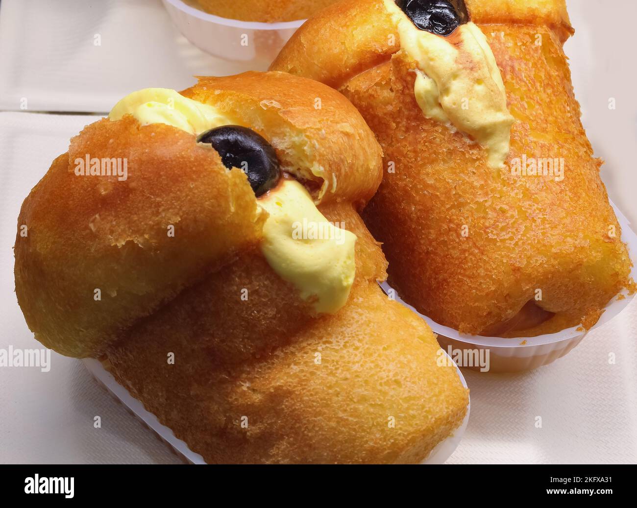 pastry called rum baba with cherry and custard Stock Photo