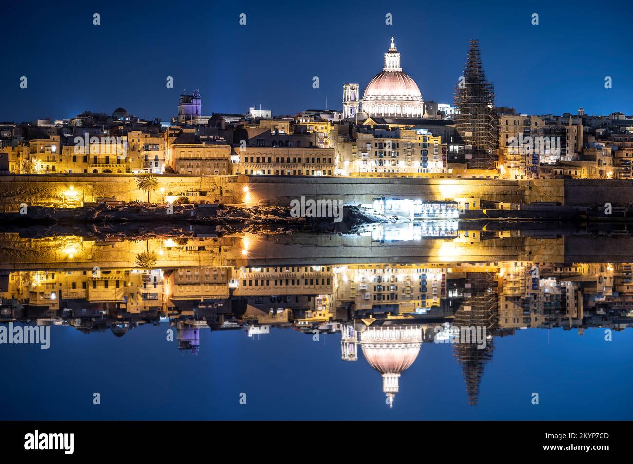 View of harbor and Valletta old town at night with reflection in water. Night Valletta. City center. Stock Photo