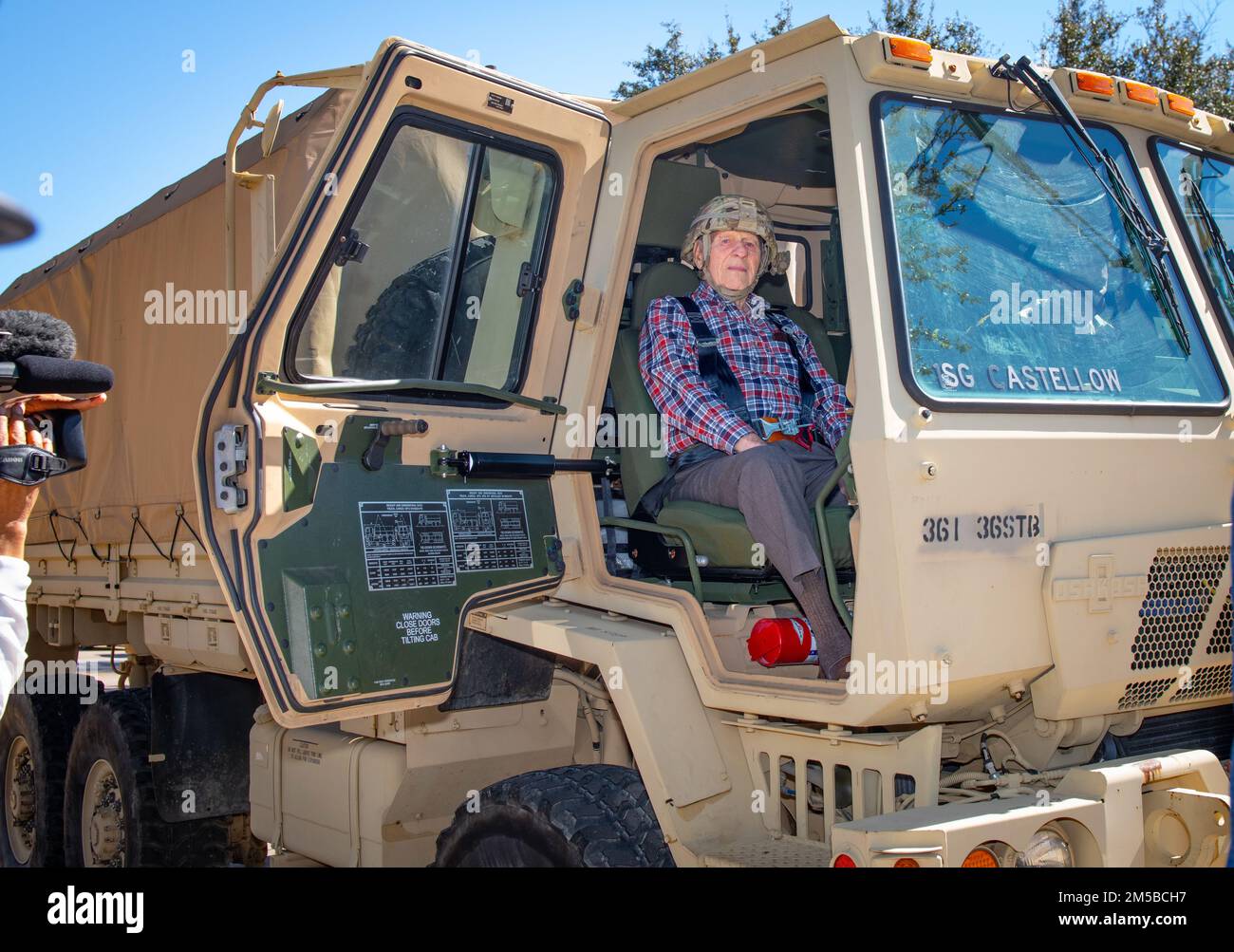 Dallas Texas -- Texas National Guardsman from 36th Sustainment Brigade do their part in granting the wish of 101 year-old WWII veteran, Jim Niederer, with a ride along in a military truck, Saturday Feb. 19, 2022. Mr. Niederer thanked the military members from his seat in the LMTV, 'Danke Schoen for everybody, it's people like ya'll that have made my experience worth while,' he said.  As a well decorated WWII Soldier from the 36th Infantry Division he survived beach invasions, German Shelling and the liberation of concentration camps. He ran supplies to the front lines in six-by-six trucks and Stock Photo