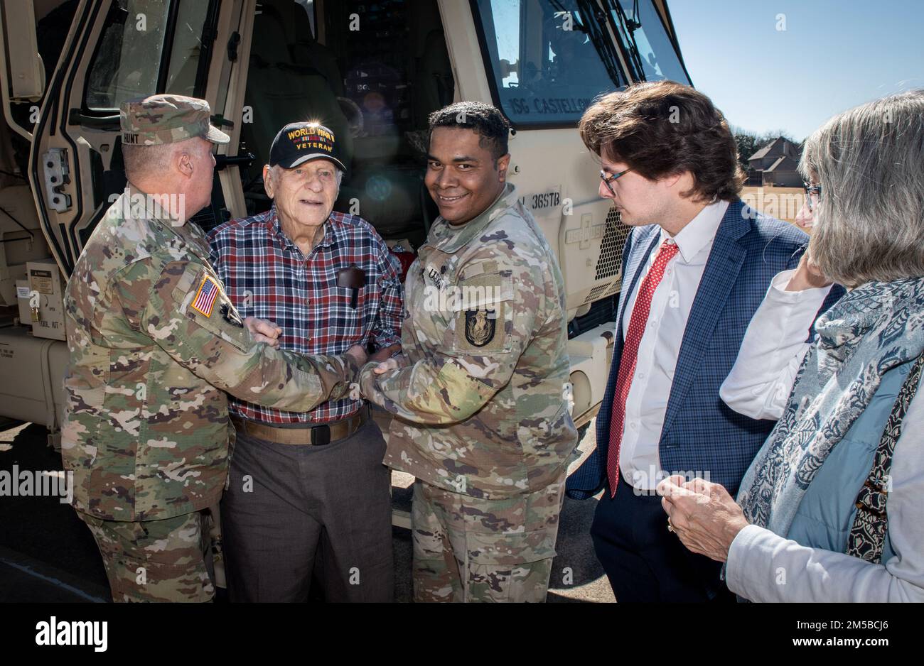 Dallas Texas -- Texas National Guardsman from 36th Sustainment Brigade do their part in granting the wish of 101 year-old WWII veteran, Jim Niederer, with a ride along in a military truck, Saturday Feb. 19, 2022. Mr. Niederer is a well decorated WWII Soldier from the 36th Infantry Division; surviving beach invasions, German Shelling and liberating concentration camps. He ran supplies to the front lines in six-by-six trucks and his wish was to ride in a military truck one more time. Stock Photo