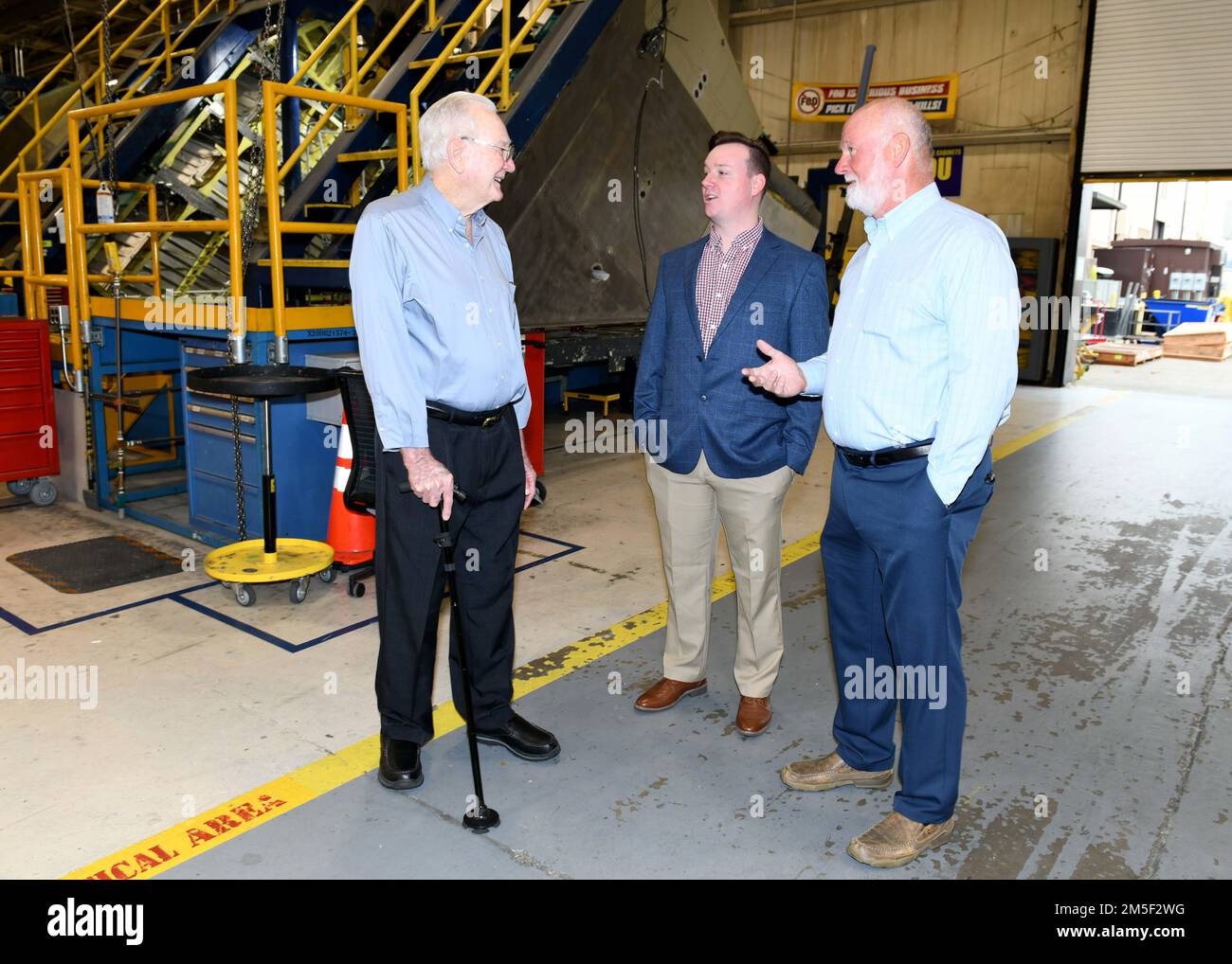 Steve Arflin, right, Robins Air Force Base retiree, Ryan Arflin, center, Warner Robins Air Logistics Complex Training Data Analysis and Training Modernization specialist, and G. L. Arflin, Robins Air Force Base retiree, visit the 402nd Commodities Maintenance Group F-15 aircraft wing section at Robins Air Force Base, Georgia, March 10, 2022. The family members represent three of four Arflin family generations that have worked at Robins Air Force Base since 1945. Stock Photo