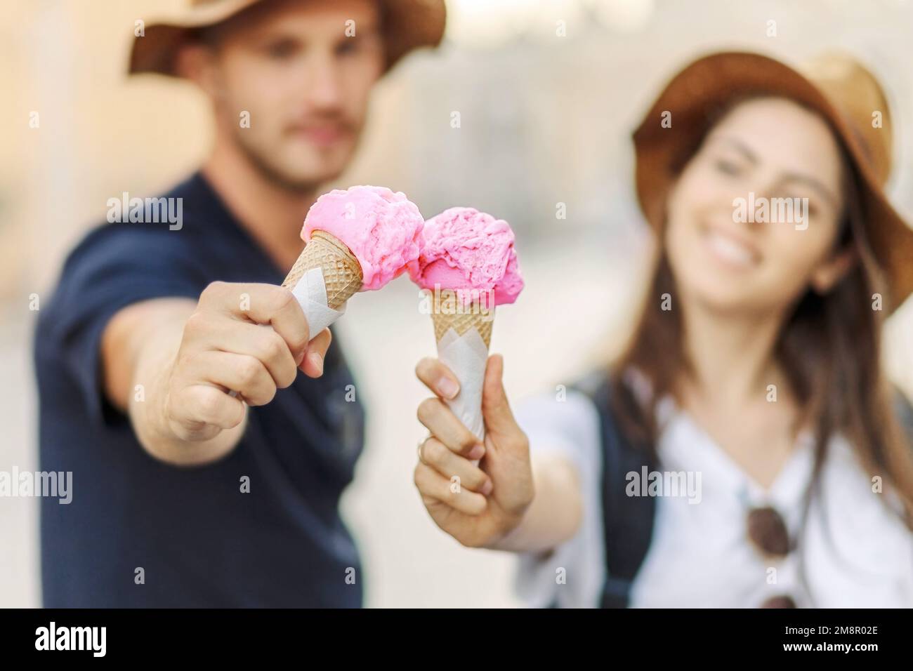 Happy couple eating ice cream in Rome, Italy. Beautiful bright ice cream with different flavors in the hands of a couple Stock Photo