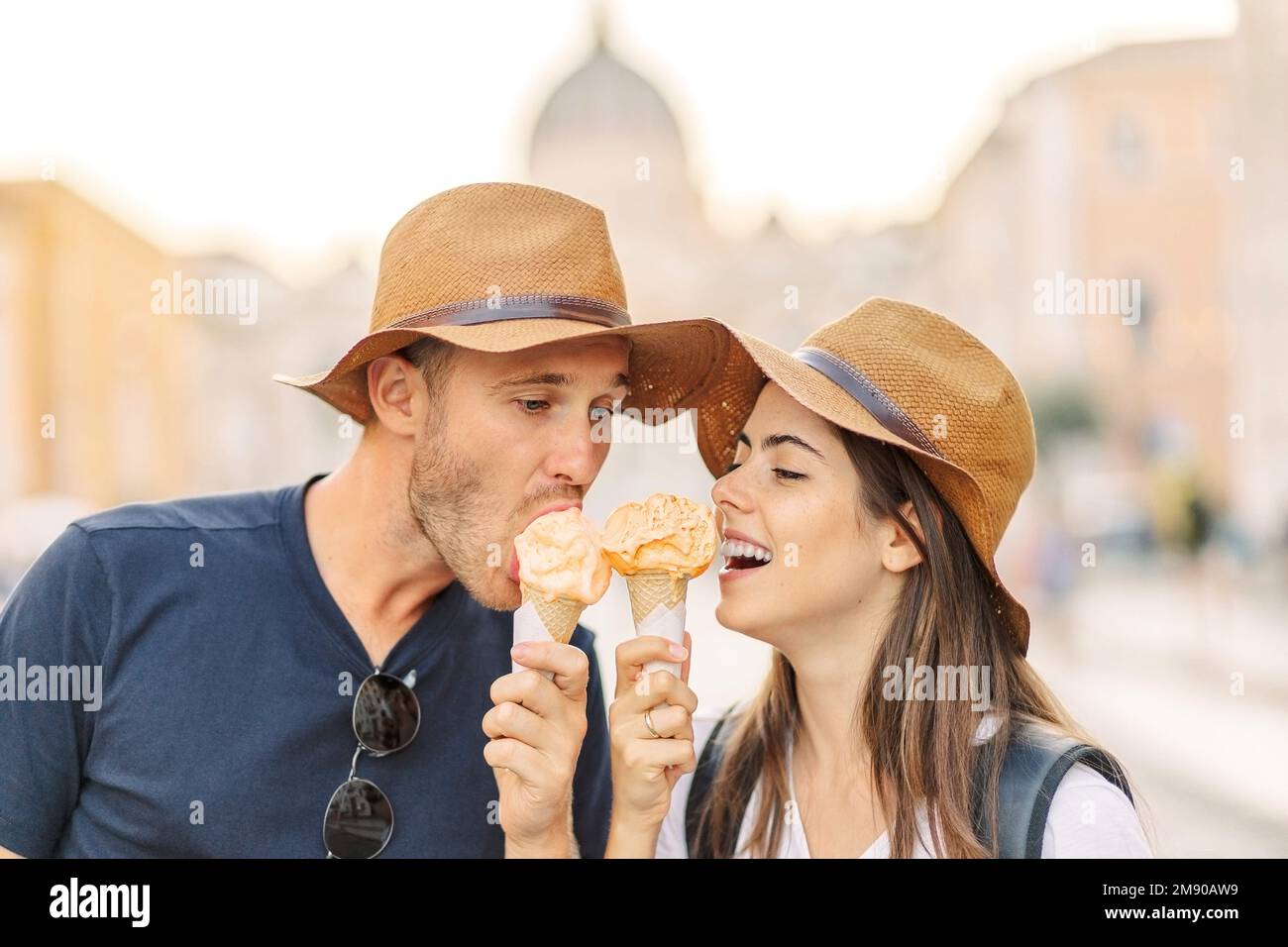 Happy couple eating ice cream in Rome, Italy. Beautiful bright ice cream with different flavors in the hands of a couple Stock Photo