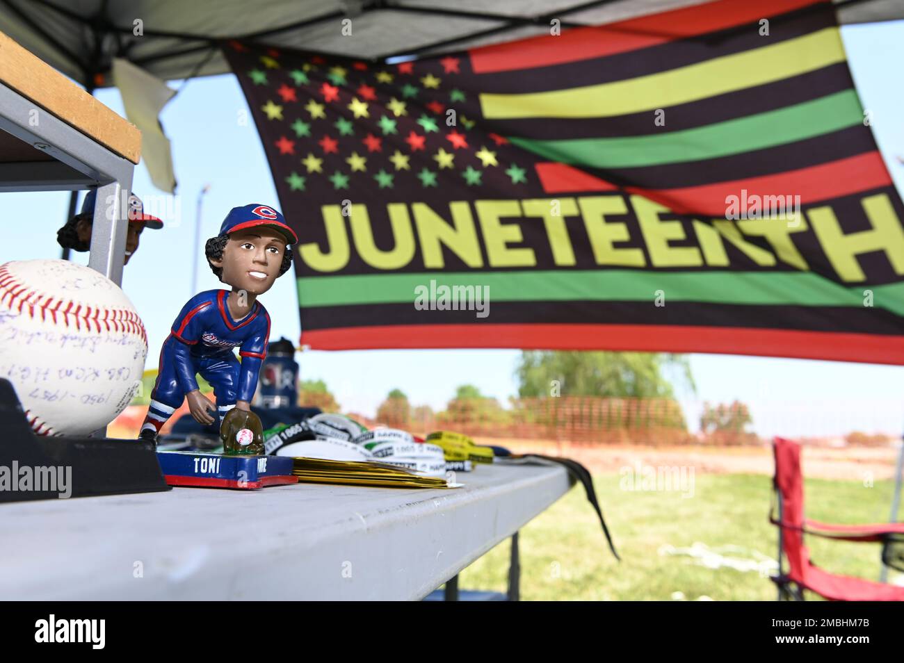 A bobble head of Toni Stone in front of a Juneteenth flag at Whiteman Air Force Base, Missouri, June 16, 2022. Toni Stone was the first of three women to play professional baseball for the Indianapolis Clowns. Stock Photo