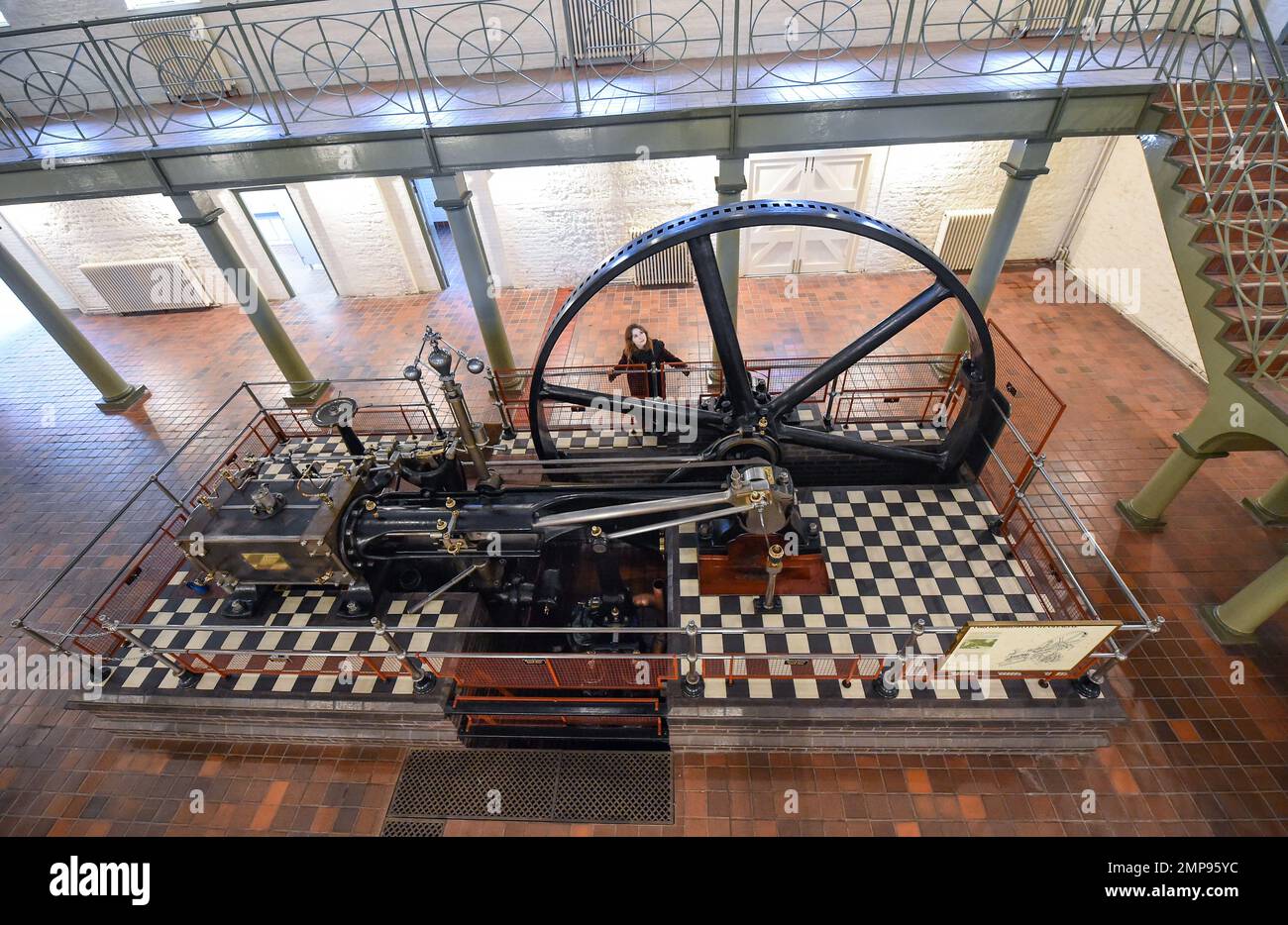 Brighton UK 31st January 2023 - Sasha Thomas from Bonhams takes a look at the rare 91hp Corliss & Wheelock Horizontal Steam Engine at Hove Engineerium and is being offered for sale at The ConnoisseurÕs Library Sale at Bonhams Knightsbridge on 7-8 February 2023 . The steam engine was built by Crepelle et Garand Lille , France in 1889 is still in working order and has an estimate of £20,000-£30,000.: Credit Simon Dack / Alamy Live News Stock Photo