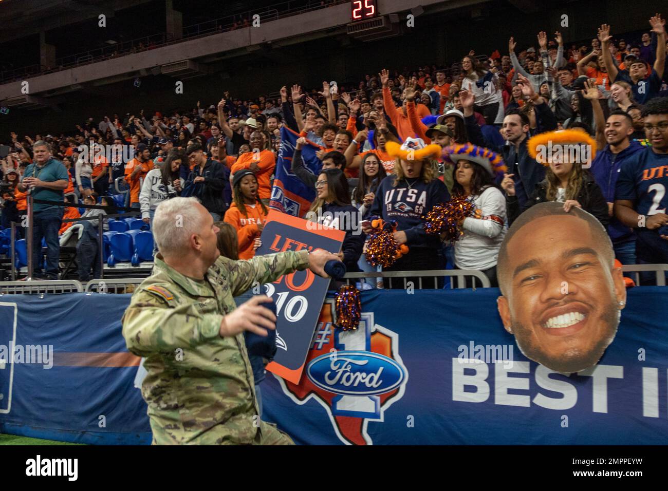 U.S. Army Lt. Gen. John R. Evans throws footballs to the audience at a ...