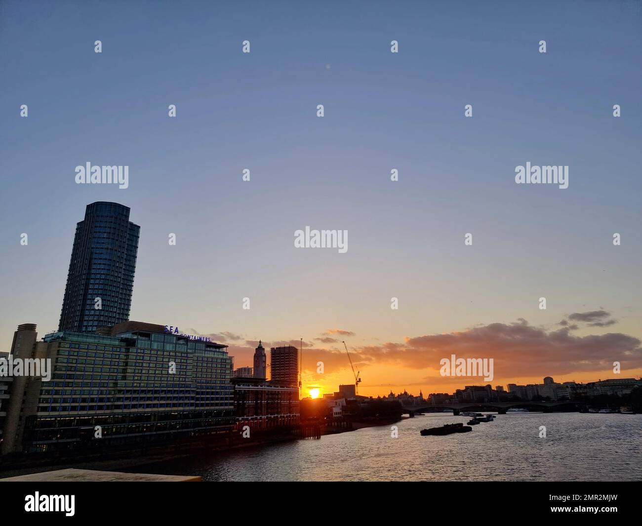 River Thames glides past London at sunset. England. Stock Photo