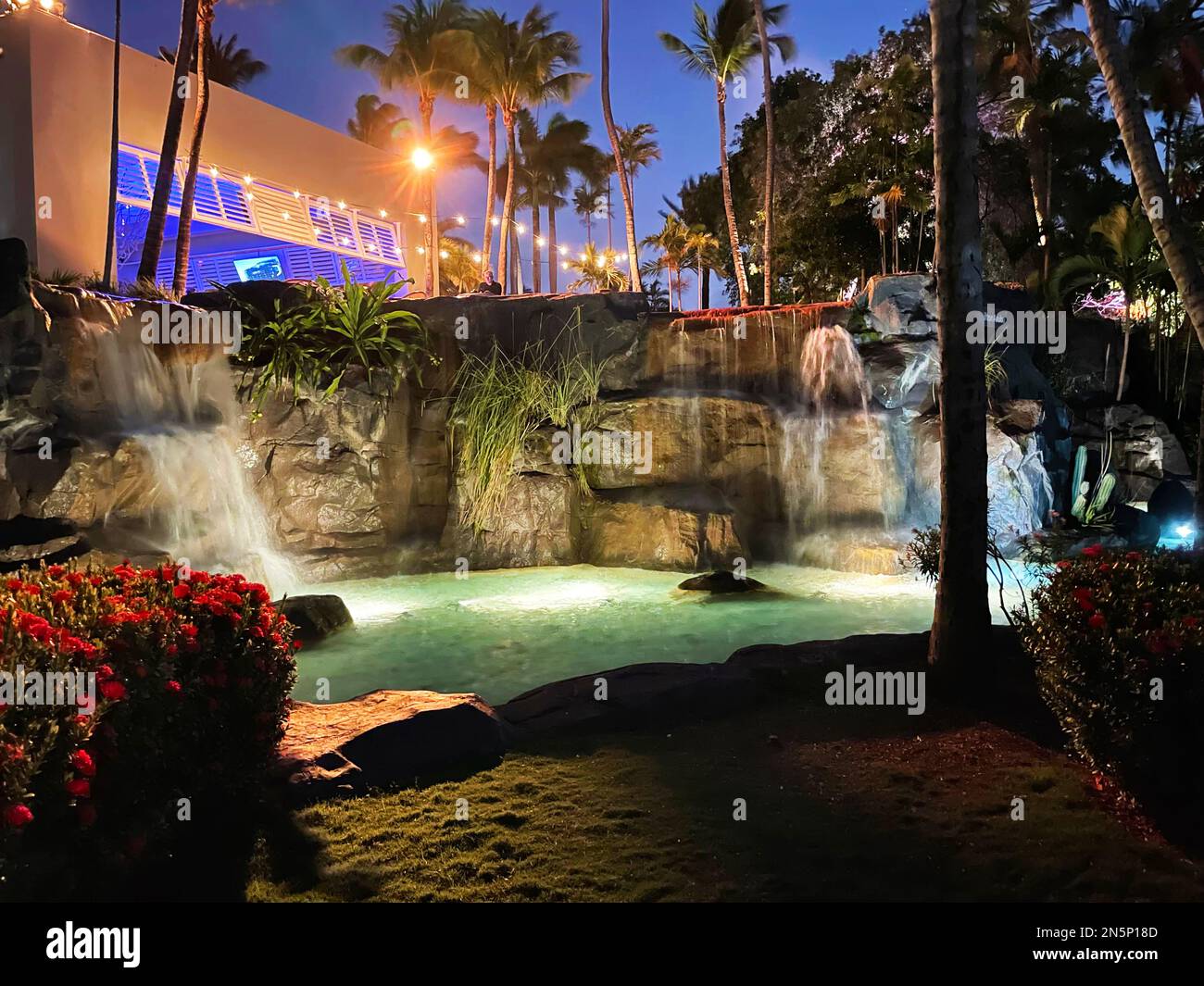 A man made waterfall at night, on a tourist resort in Aruba. Stock Photo