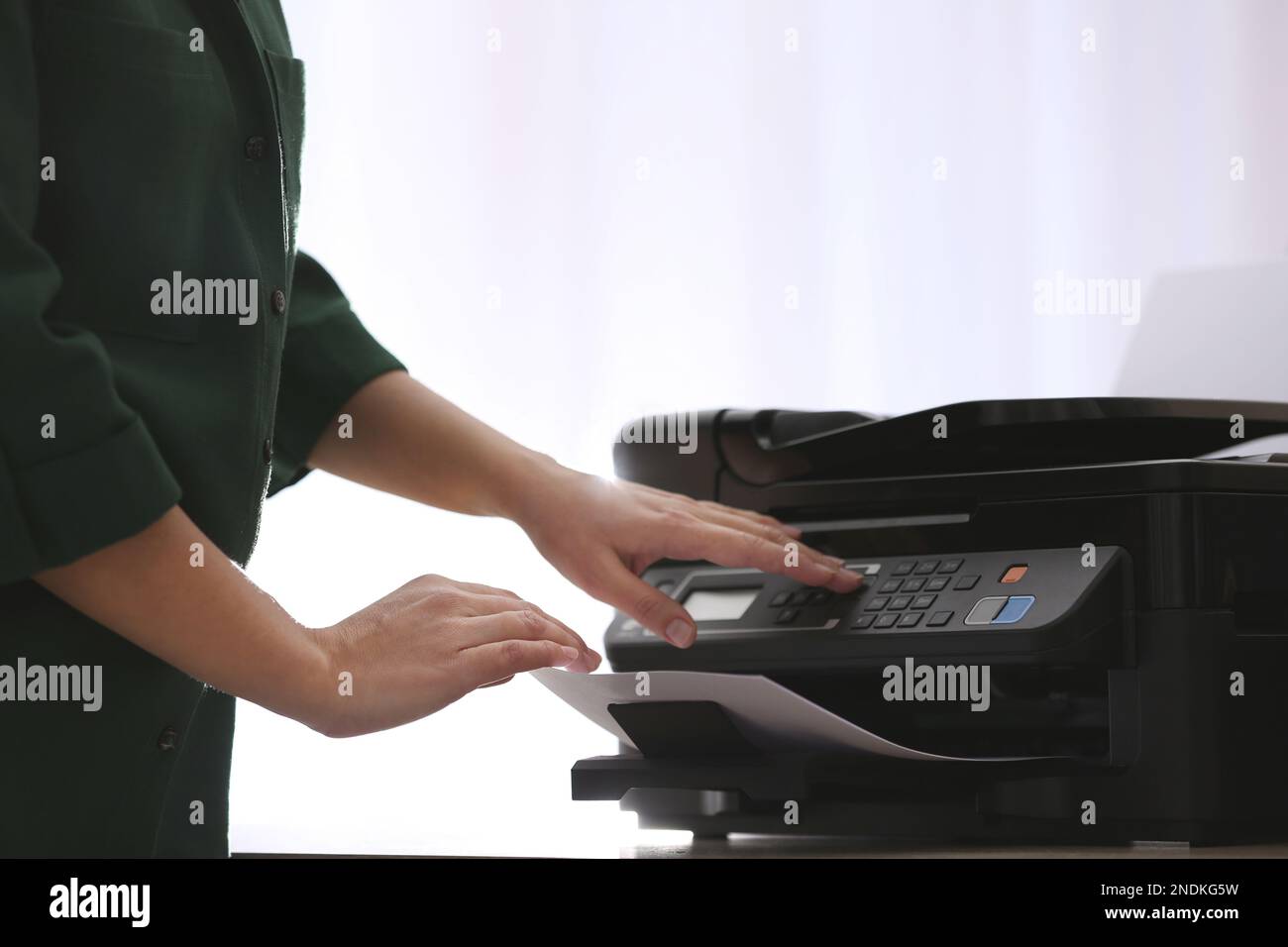 Employee using modern printer in office, closeup Stock Photo