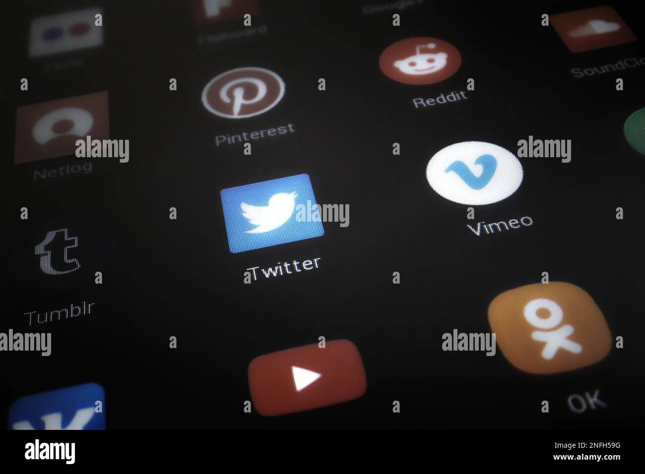 Close up on a tablet screen focused on the Twitter logo amongst other competititor apps. Stock Photo