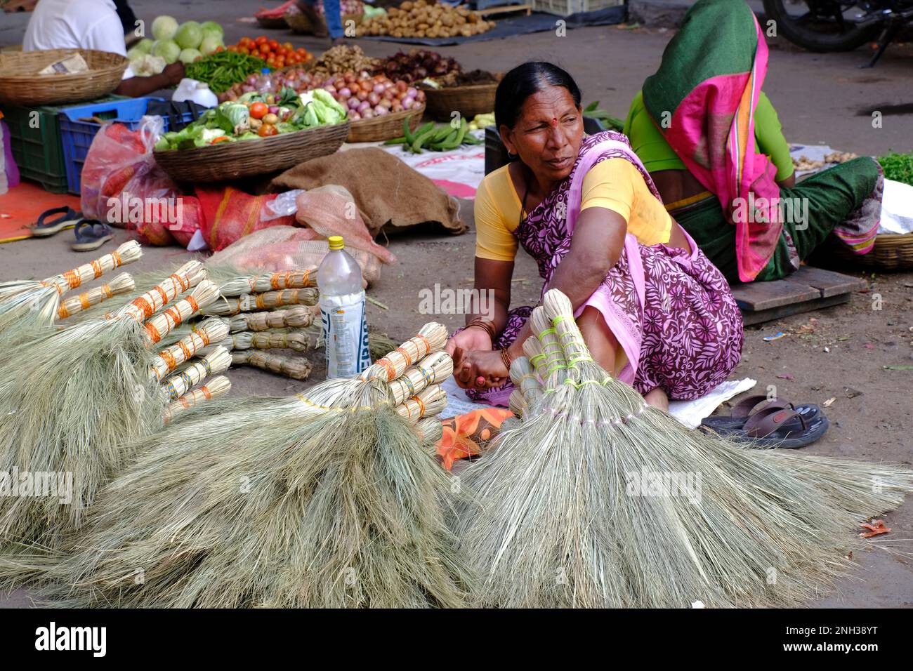 30 Jan 2023, Indian woman selling brooms in Phaltan Market, traditionally made using natural elements, Maharashtra, India. Stock Photo