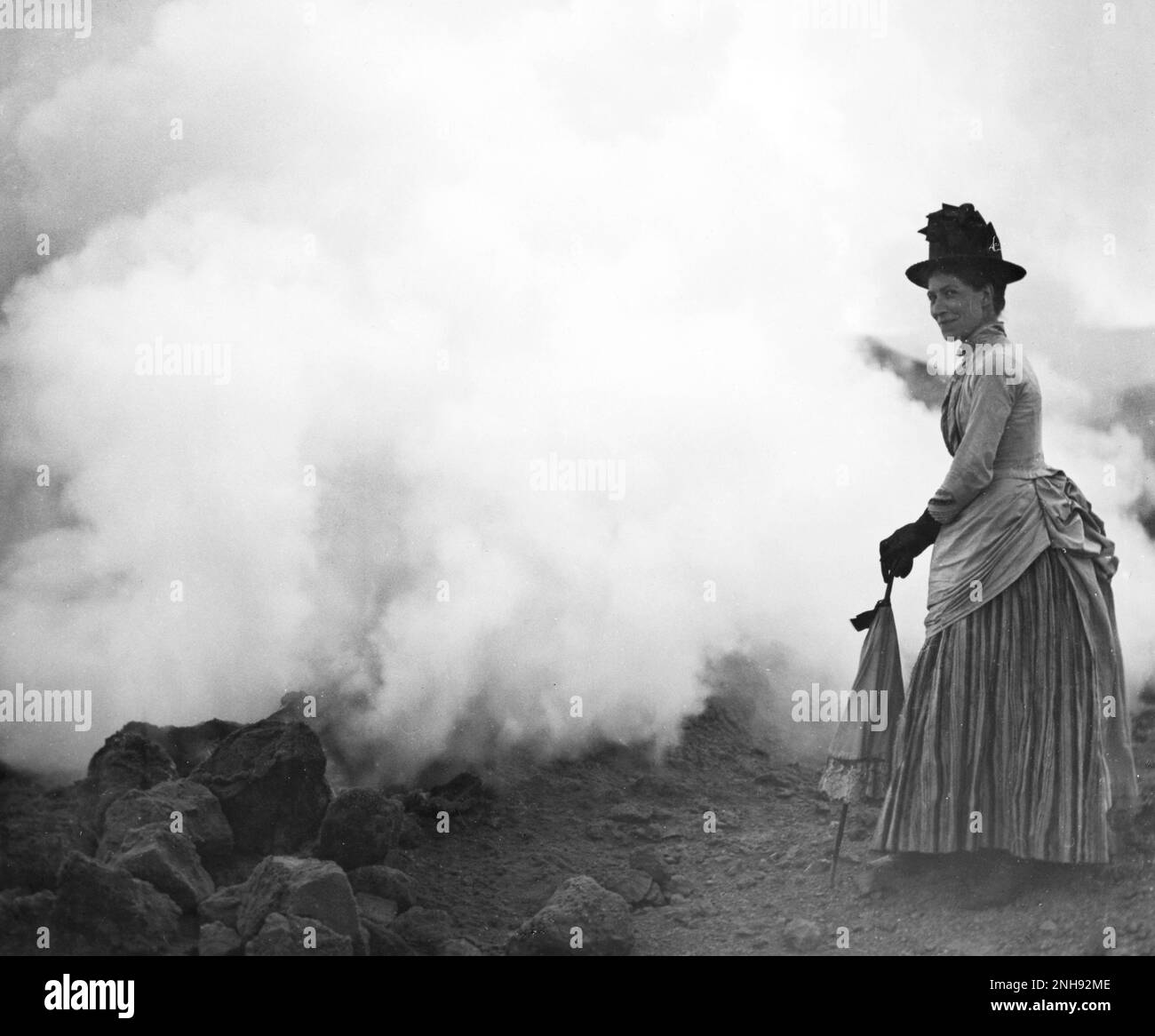 Woman with parasol on active crater rim, Vulcano, Aeolian Islands, Italy, circa 1880s. Glass lantern slide by Tempest Anderson (1846-1913). Stock Photo