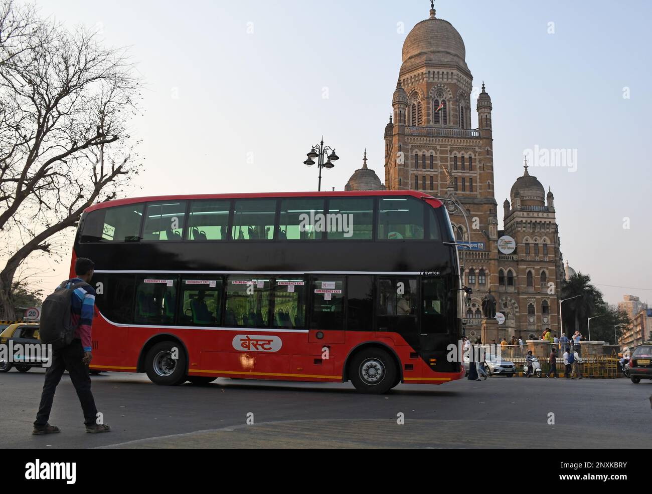 An airconditioned electric double decker bus drives by Brihanmumbai Municipal Corporation (BMC) building in Mumbai. The bus ferries office-goers on the route from Chhatrapati Shivaji Maharaj Terminus (CSMT) to Nariman Point. Stock Photo