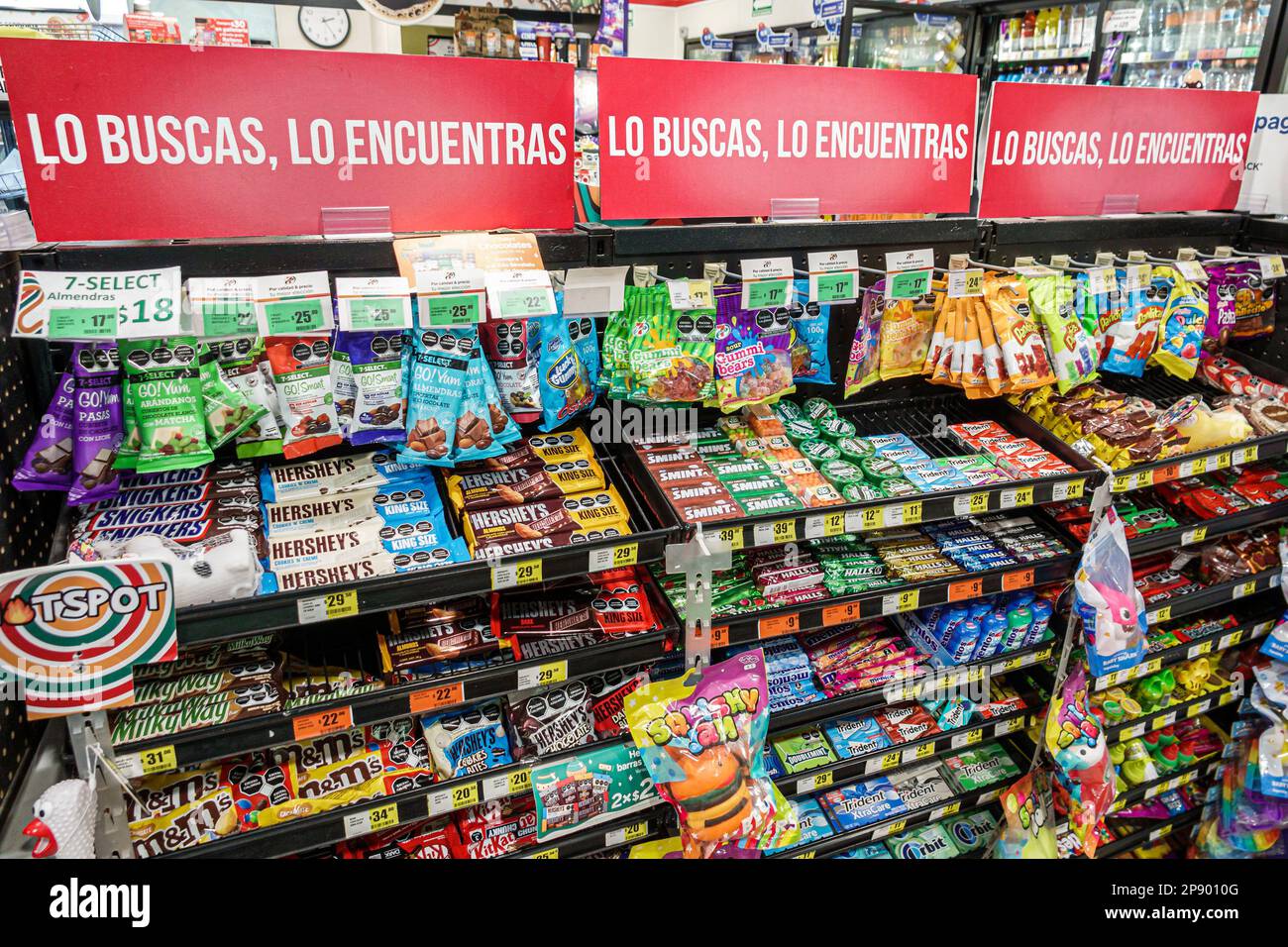 Mexico City,snacks snack junk food candy bars,Hershey's M&M's,inside interior indoors,7-Eleven convenience food store stores,bodega bodegas grocery,di Stock Photo