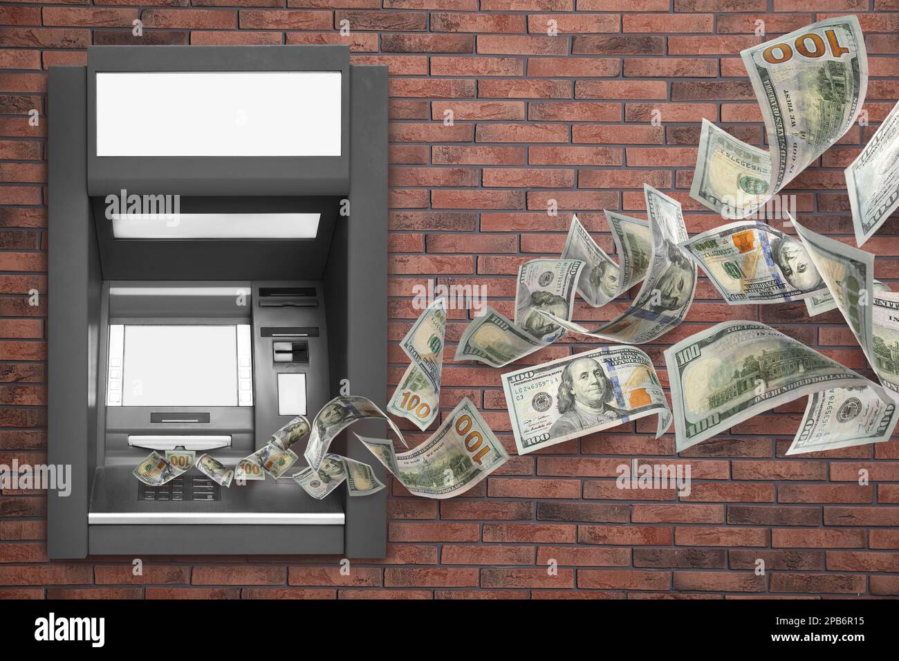 Modern automated cash machine on brick wall and flying money Stock Photo