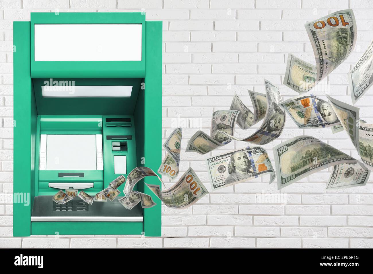 Modern automated cash machine on white brick wall and flying money Stock Photo