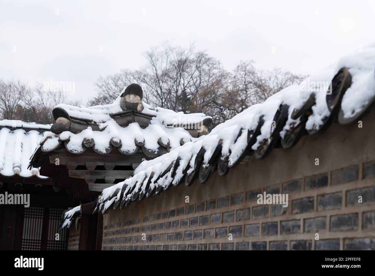 snow covered Korean traditional roof tile Stock Photo