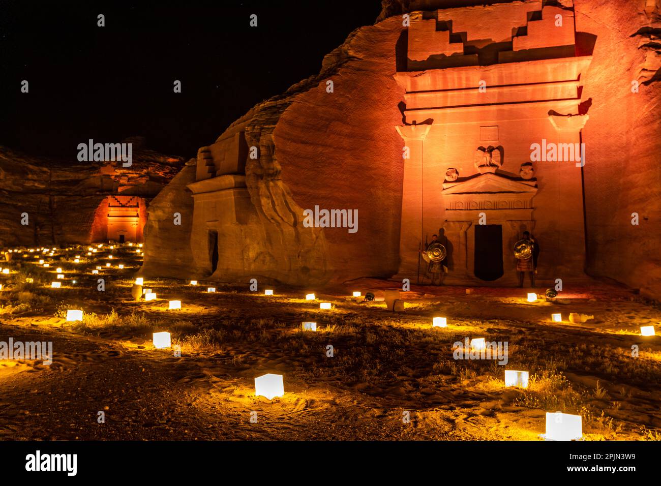 Ancient tombs of Hegra city illuminated during the night, Al Ula, Saudi ...