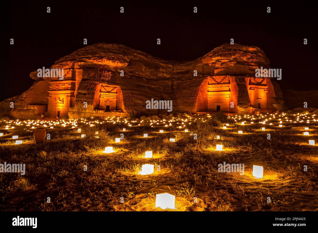 Ancient tombs of Hegra city illuminated during the night, Al Ula, Saudi ...