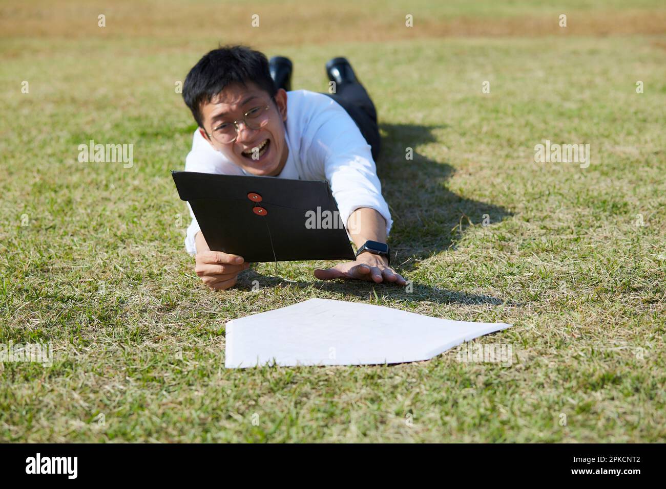 Man in suit with material sliding to home base Stock Photo