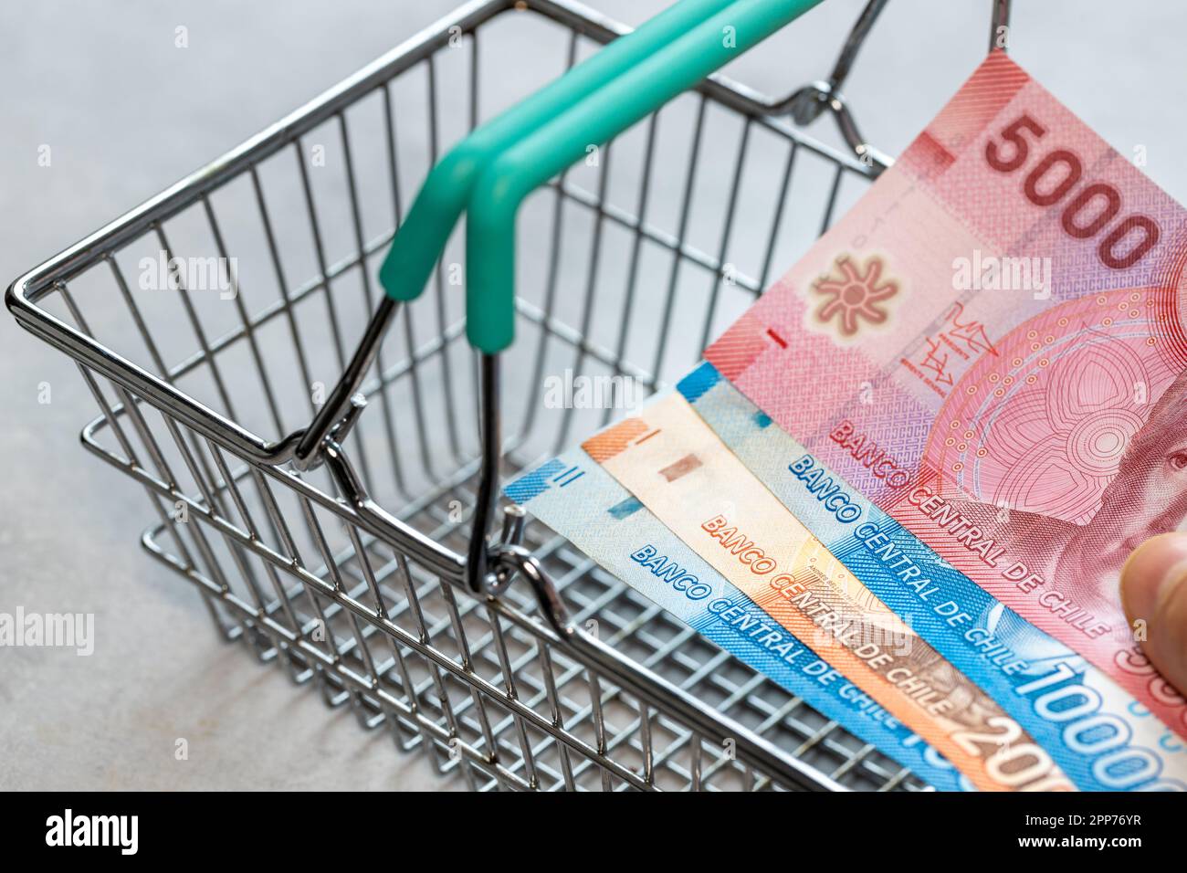 Concept, Chile inflation, Empty shopping cart and chile pesos file, close up Stock Photo