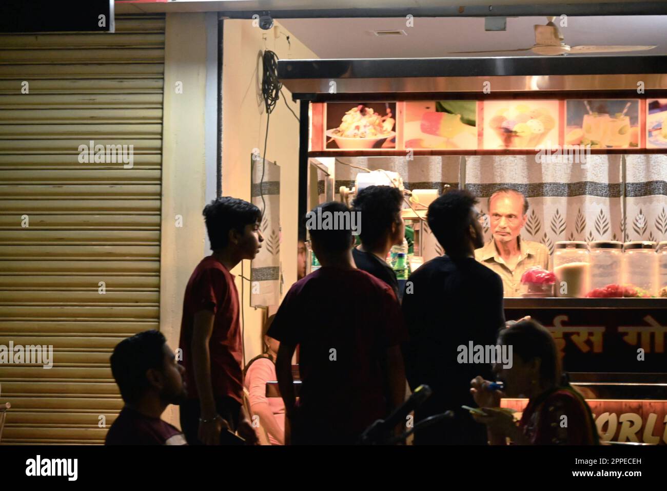 City : nagpur; 23 April 2023 Description : boys standing in front of a ice cream soda stall in the blazing summer Stock Photo