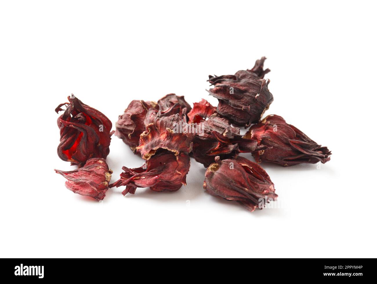 Hibiscus tea on a white background close-up. Dry flowers of red hibiscus on isolation. A handful of hibiscus for making tea. Stock Photo