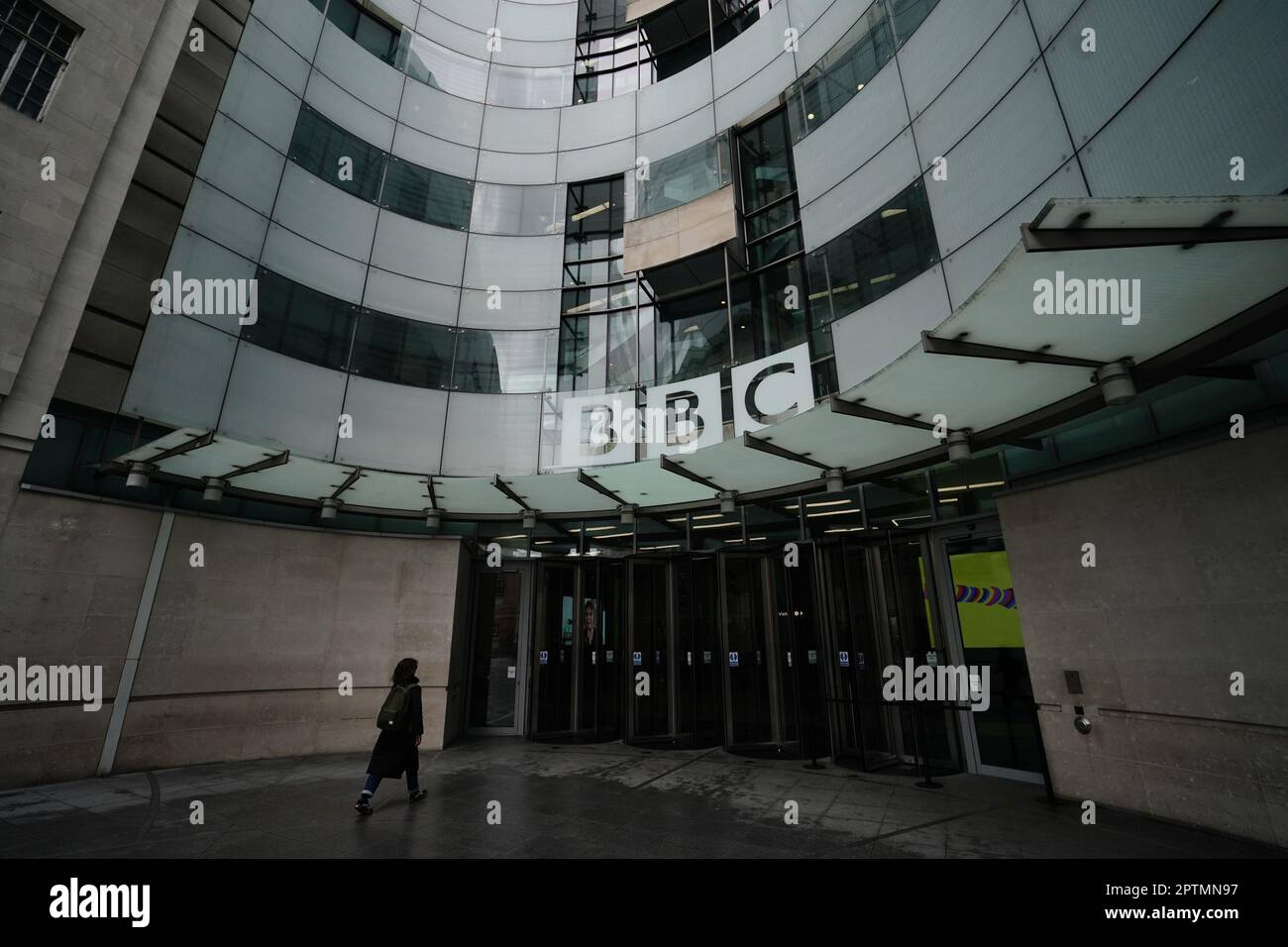 A screen showing a news report seen through the windows of the BBC in central London, after chairman Richard Sharp announced he was quitting as BBC chairman to 'prioritise the interests' of the broadcaster after a report by Adam Heppinstall found he breached the governance code for public appointments. after an official report found he breached the rules for public appointments. Mr Sharp conceded after Adam Heppinstall KC's report into his appointment found he 'failed to disclose potential perceived conflicts of interest'. Picture date: Friday April 28, 2023. Stock Photo