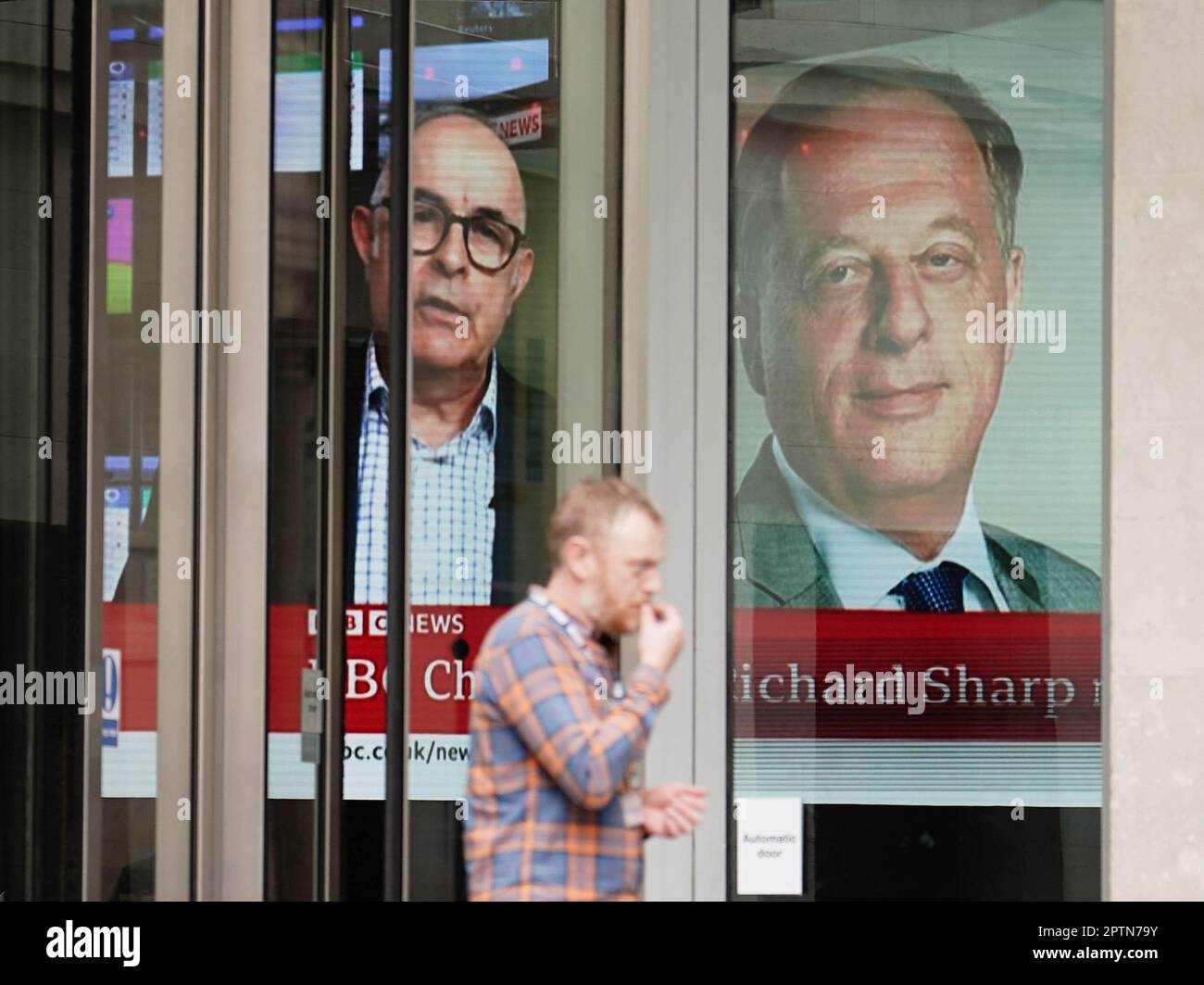 A screen showing a news report through the windows of the BBC in central London, of BBC chairman Richard Sharp (right) who announced he was quitting as BBC chairman to 'prioritise the interests' of the broadcaster after a report by Adam Heppinstall found he breached the governance code for public appointments. Mr Sharp conceded after Adam Heppinstall KC's report into his appointment found he 'failed to disclose potential perceived conflicts of interest'. Picture date: Friday April 28, 2023. Stock Photo