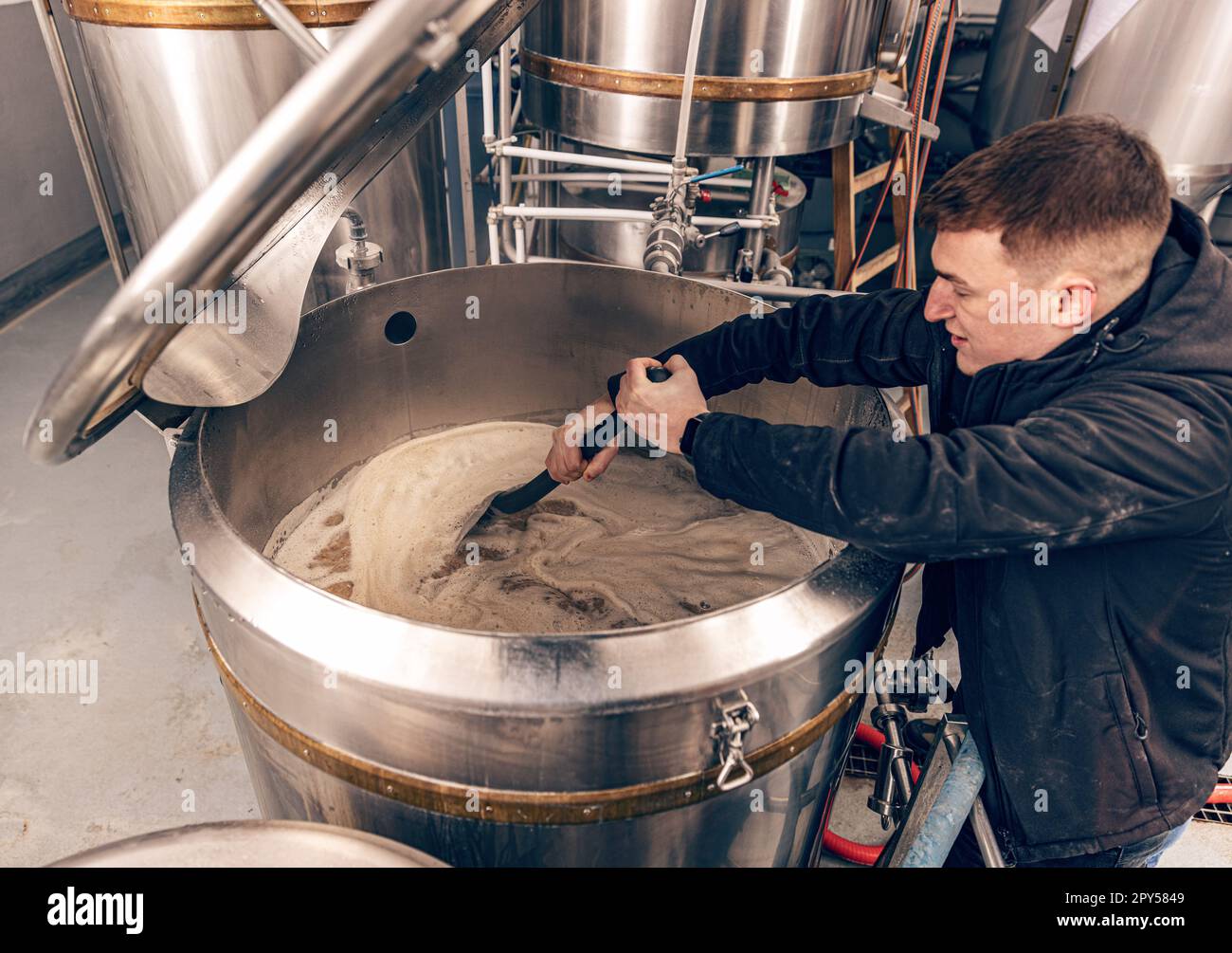 Brewery worker controlling process Stock Photo