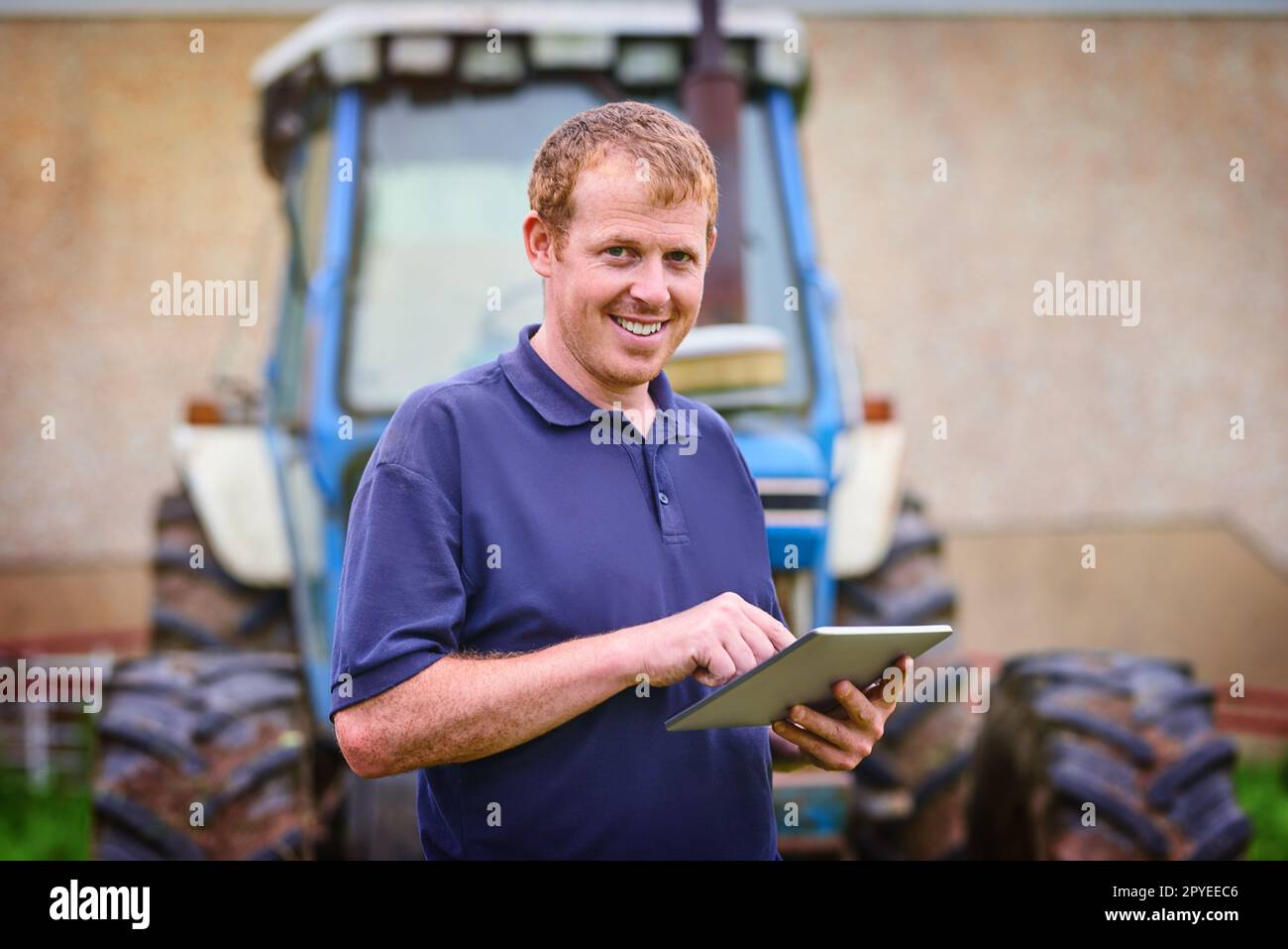 These apps were made with a farmer in mind. a farmer using a digital tablet on his farm. Stock Photo