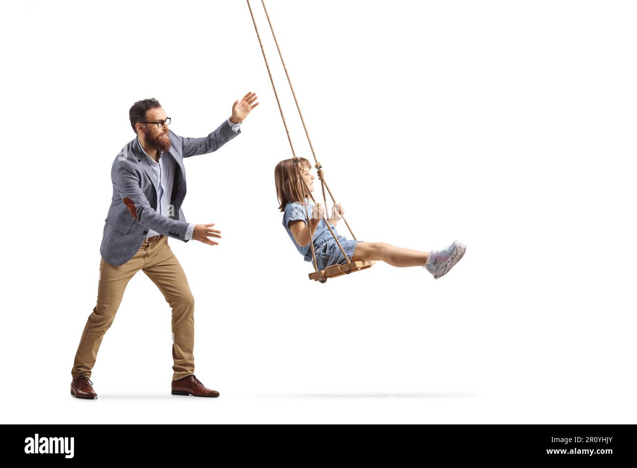 Father pushing a little girl on a swing isolated on white background Stock Photo