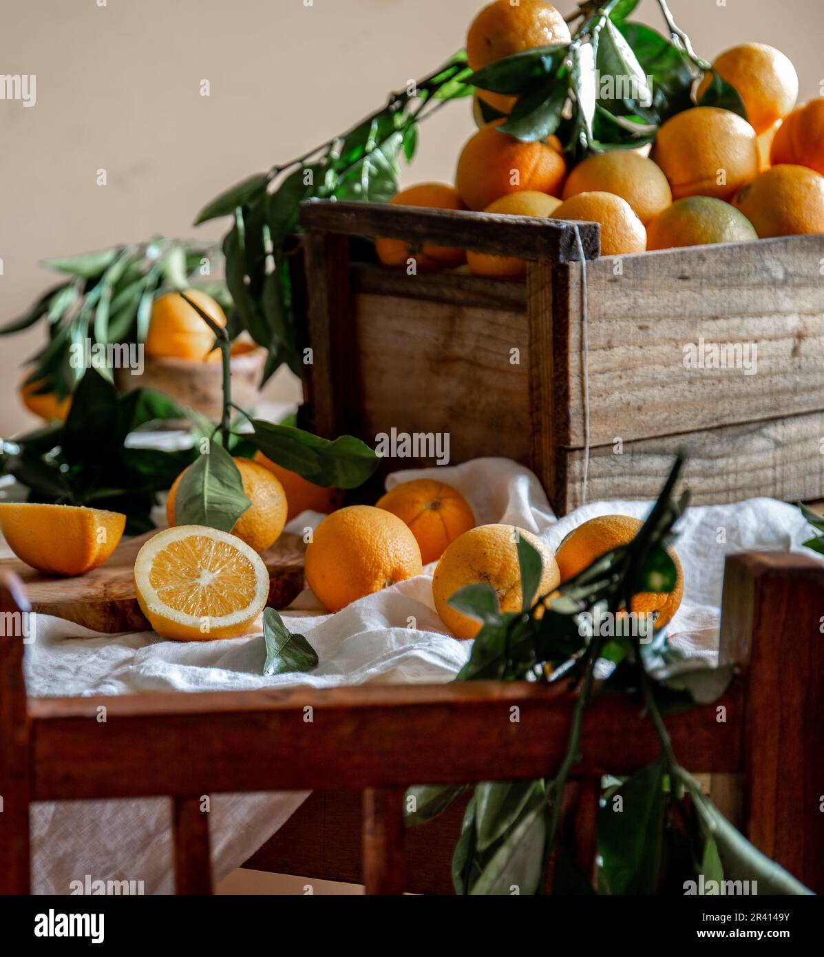 Table with box of fresh orange with orange tree branch and fresh orange juice Stock Photo