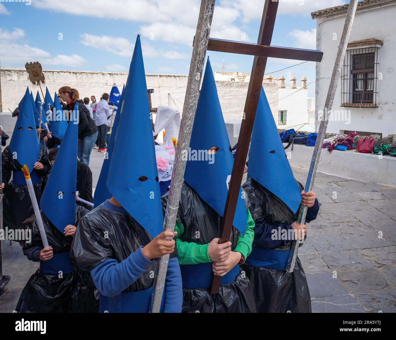 Kids with cloaks and hoods (Capirotes) at Holy Week Procession (Semana Santa) - Arcos de la Frontera, Cadiz, Spain Stock Photo